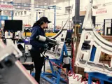 Employee working on hood assembly