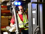 Team member on a forklift smiling at the camera