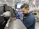 Profile shot of team member actively working on a press